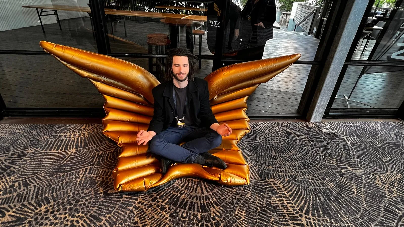 A member on the Titan wings at an event