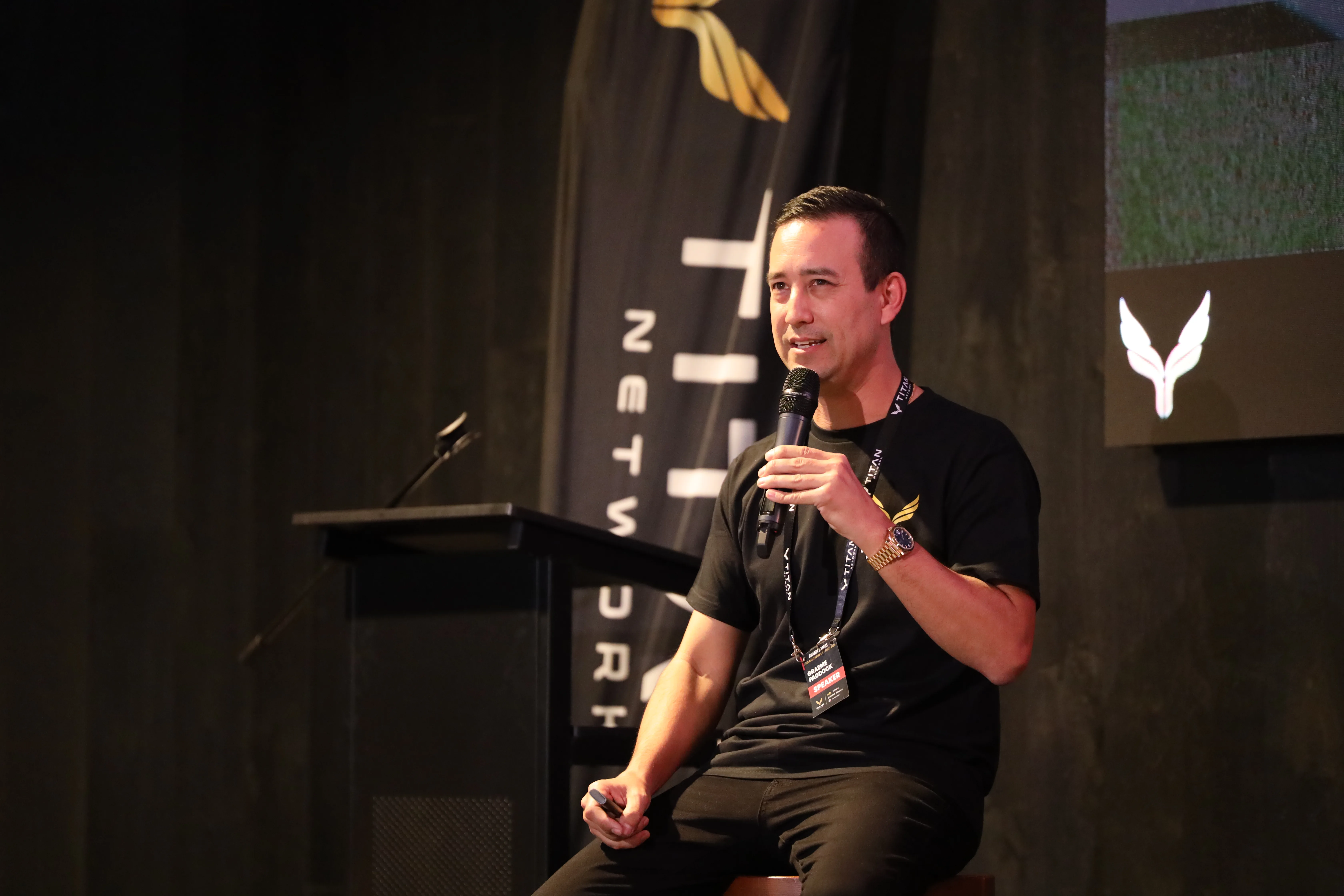 A Titan operator on stage at a mastermind